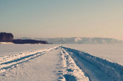 Scenic view of snow covered mountains against clear sky