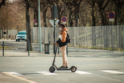 Full length of man skateboarding on road