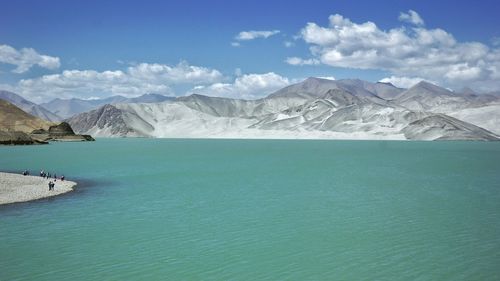 Scenic view of sea and mountains against sky