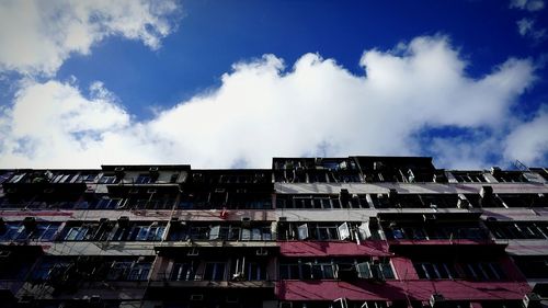 Low angle view of building against cloudy sky