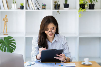 Young woman using laptop at home