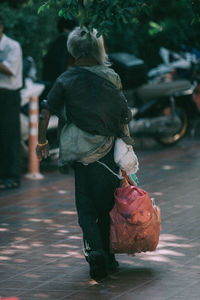 Rear view of girl walking on road