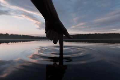 Low section of woman standing in water