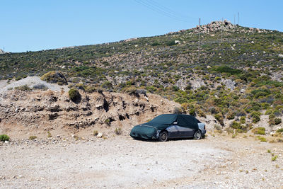 A covered car in the landscape in the island of patmos, greece