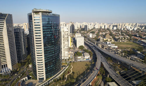 High angle view of street amidst buildings against clear sky