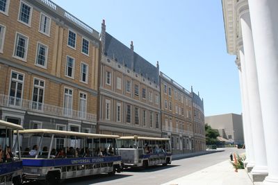 People walking in city against clear sky