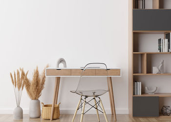 Empty white wall in modern home office. mock up interior in scandinavian, boho style. free space