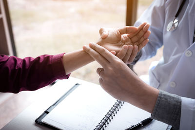 Close-up of hands holding table