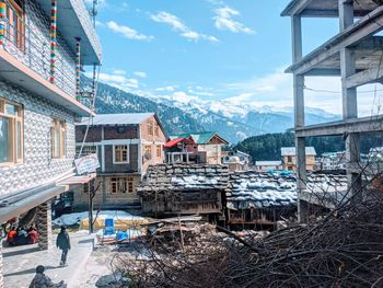 Houses in city against sky during winter