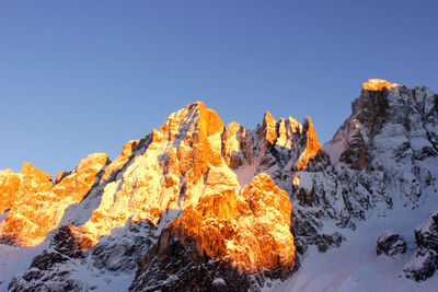 Scenic view of snow mountains against clear blue sky