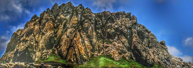 Low angle view of rock formation against sky