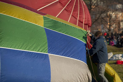 Rear view of man photographing with umbrella