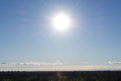 Scenic view of landscape against sky on sunny day