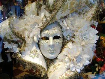 Close-up of carnival mask at window display