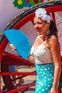 Midsection of smiling woman holding hat