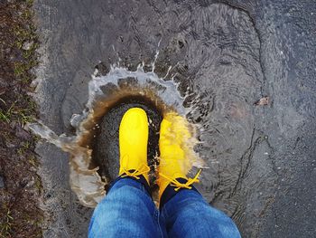 Low section of man standing on water