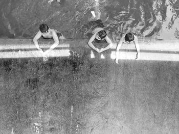 High angle view of boys swimming in pool