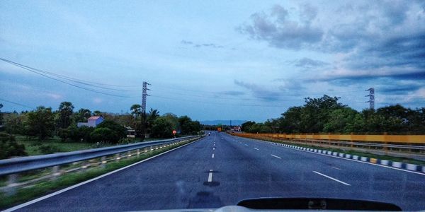 Road seen through windshield of car