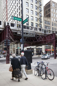 Rear view of man walking on city street