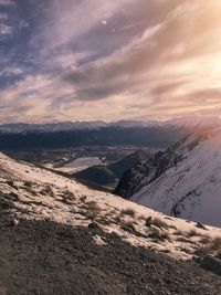 Scenic view of snowcapped mountains against sky during sunset