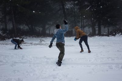 People playing with dog on snow