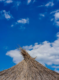 Low angle view of roof against blue sky