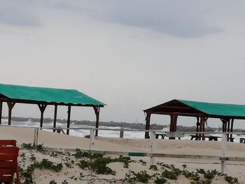 Lifeguard hut on beach against sky