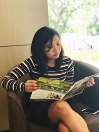 Young woman sitting at home