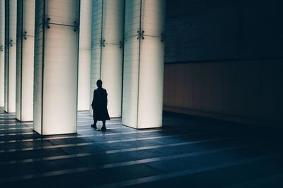 Rear view of man walking in building