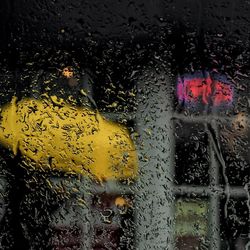 Close-up of wet glass window in rainy season