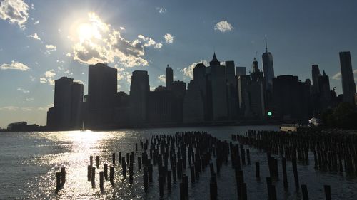 Panoramic view of city by sea against sky