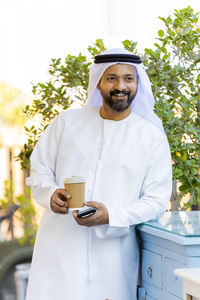 Portrait of smiling man holding coffee
