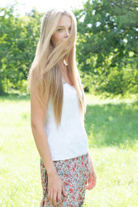 Portrait of beautiful teenage girl standing on field