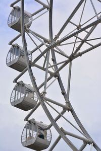 Low angle view of ferris wheel against sky