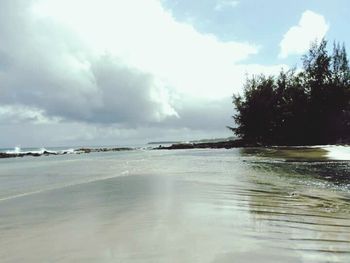 Scenic view of sea against cloudy sky