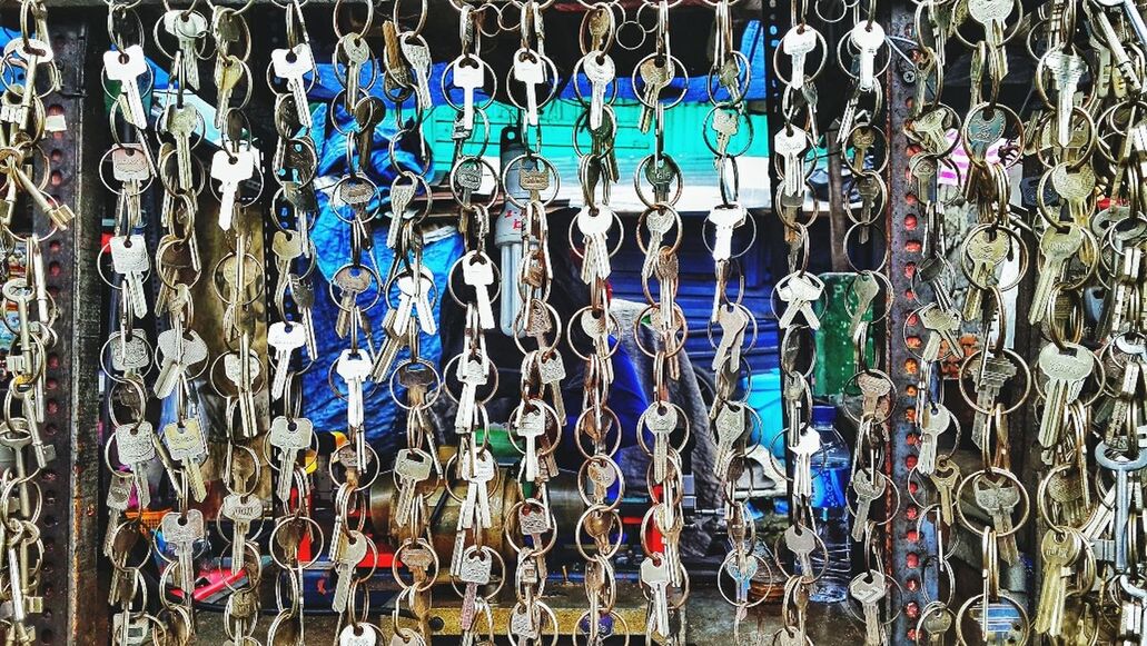 large group of objects, abundance, hanging, multi colored, in a row, padlock, protection, variation, fence, full frame, backgrounds, metal, safety, security, lock, blue, day, wall - building feature, wood - material, outdoors
