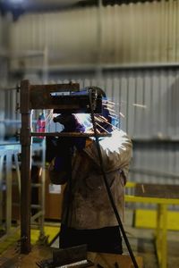Man holding umbrella in city at night