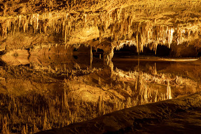 Underground lake in underground subterranean cave cavern reflects intricate rock formations