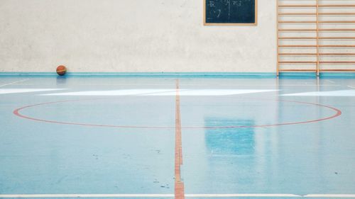 View of basketball hoop in pool against building