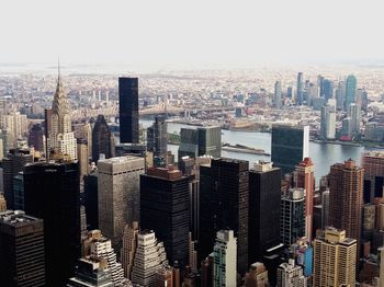 Aerial view of buildings in city against sky