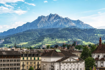 High angle view of townscape and mountains against sky