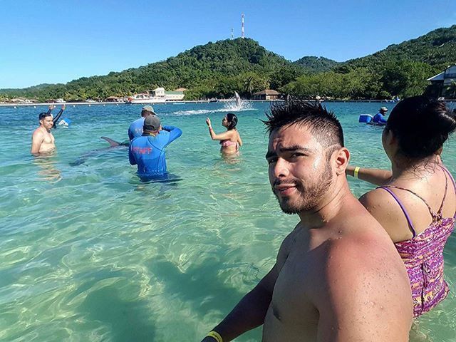 water, leisure activity, lifestyles, vacations, mountain, sea, togetherness, young adult, nautical vessel, blue, sunlight, clear sky, person, swimming, enjoyment, nature, men