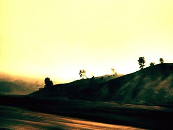 Scenic view of landscape against sky at sunset
