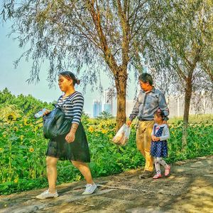 Full length of woman standing on tree trunk