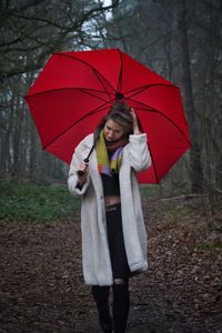 Rear view of woman holding umbrella