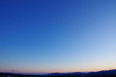 Scenic view of mountains against clear blue sky