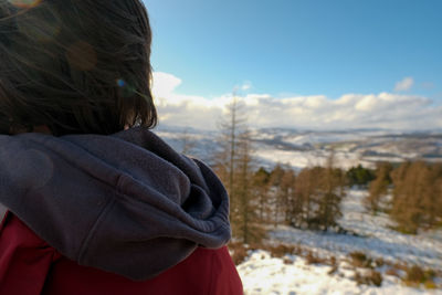 Rear view of woman on snow covered land