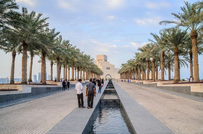 Rear view of people on footpath at museum of islamic art