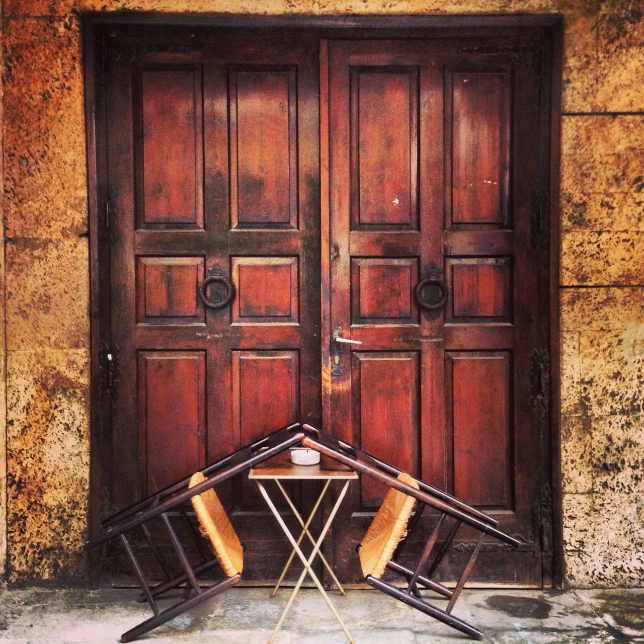 wood - material, door, built structure, architecture, wooden, absence, wood, closed, empty, house, chair, building exterior, old, red, no people, day, indoors, brown, entrance, wall