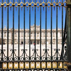 Royal palace of madrid seen through from metal gate